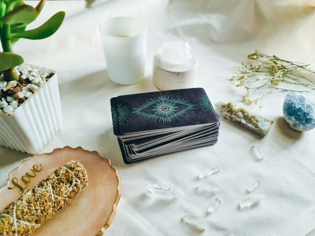 Tarot cards, crystals and candle on a reading table