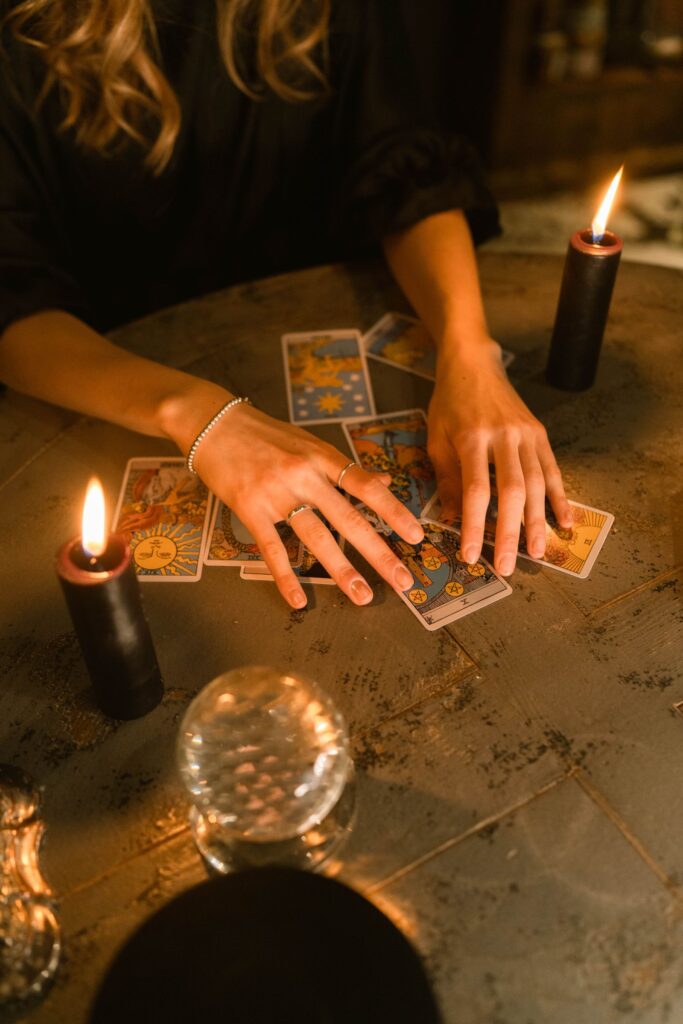 A tarot reading with candles and a crystal ball