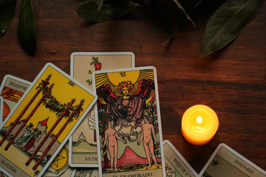 Tarot cards and candlelight in a dark mystical setting