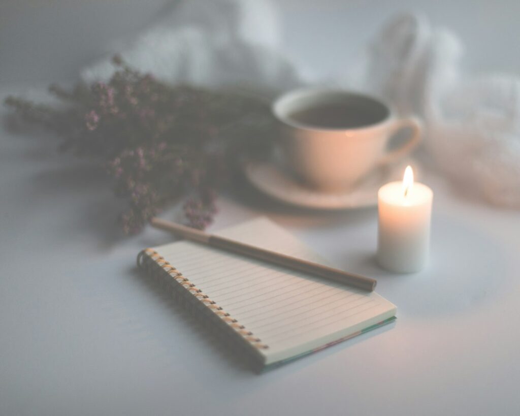 Person writing thoughtfully in a journal